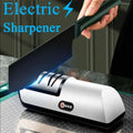 The black electric knife sharpener in use sharpening a butchers knife.