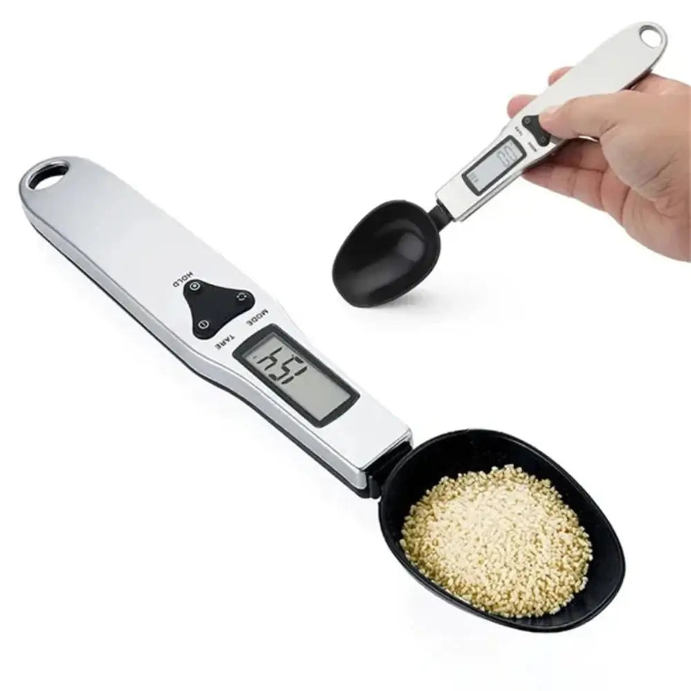 2 of the electronic measuring spoons. One filled and an empty one being held by someone.