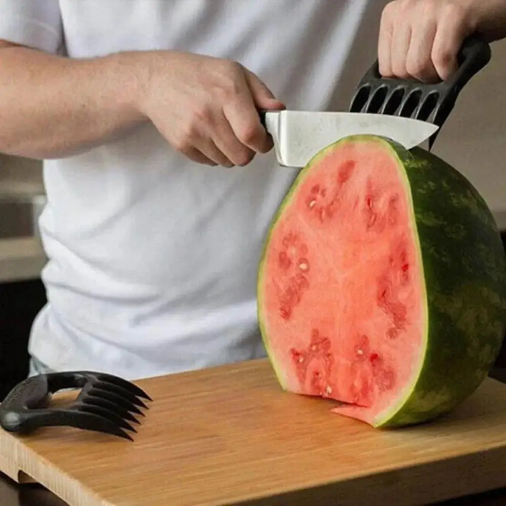 A man using the meat shredding claw to hold a watermelon while cutting into it with a knife.